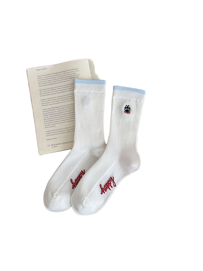 Cat socks with white ribbing, light blue cuffs, a cat motif and red foot lettering