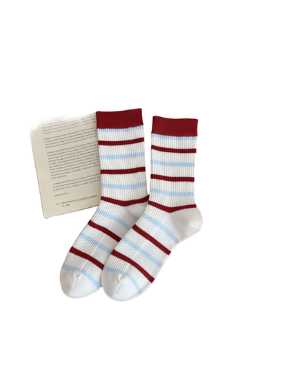 Stripes socks with red cuffs and alternating red and light blue stripes across white ribbing