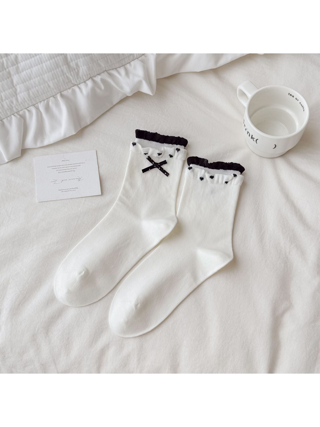 White Bow socks with black ribbon decoration and ruffled contrasting cuffs.