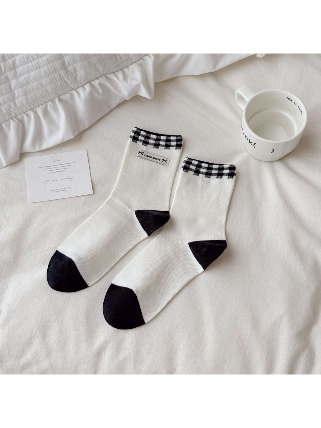Black and white Fabric Label socks with checked cuffs and contrasting heels and toes.