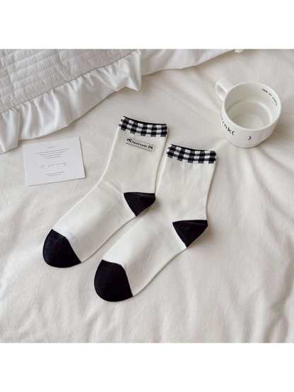 Black and white Fabric Label socks with checked cuffs and contrasting heels and toes.
