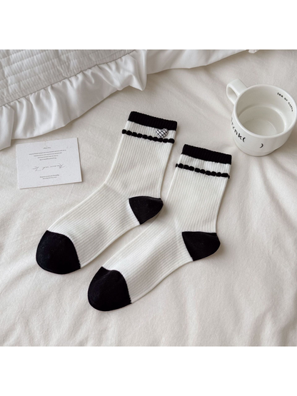 Ivory Heart socks with a plaid heart accent, black cuff bands, and contrasting heels and toes.
