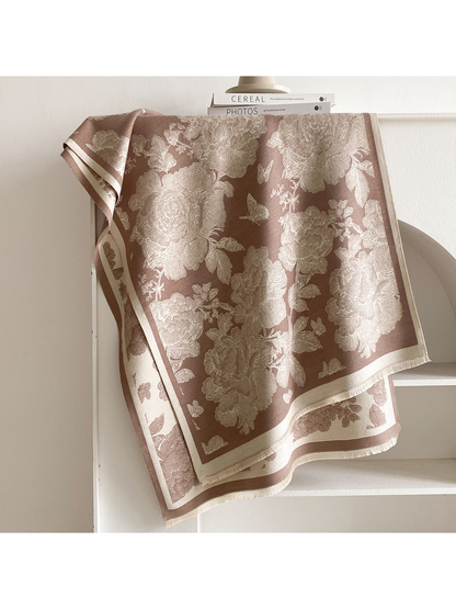 Coffee scarf draped to show cream floral and butterfly motifs, contrasting borders, and short fringe.