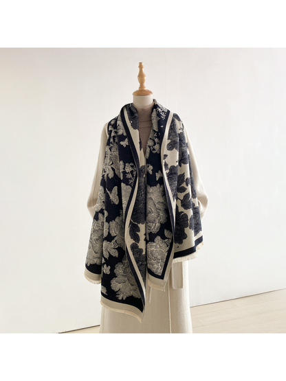 Black floral scarf draped loosely around a mannequin's neck, with long hanging ends and both contrasting sides visible.