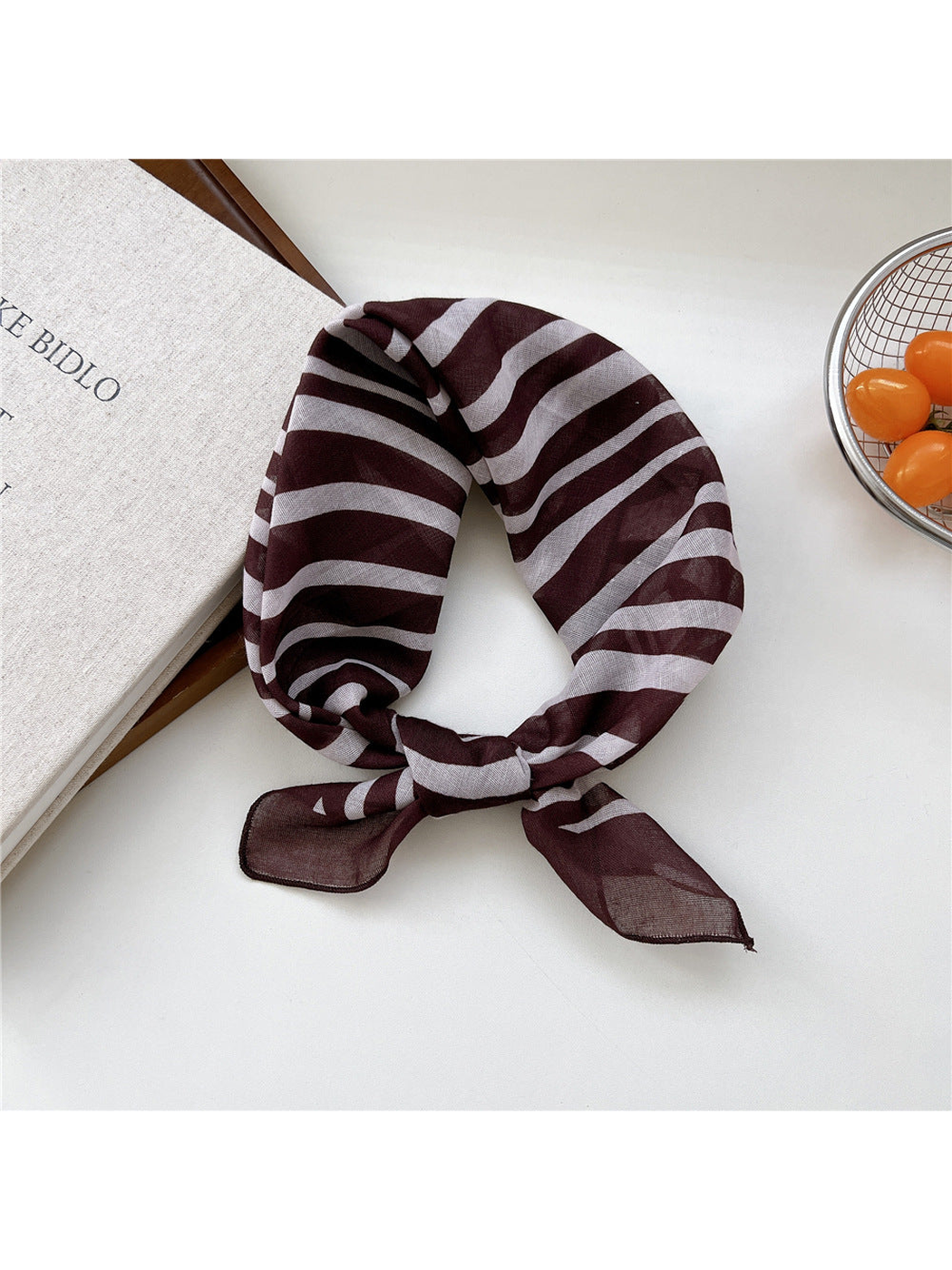 Brown Zebra scarf tied in a loop with irregular white stripes.