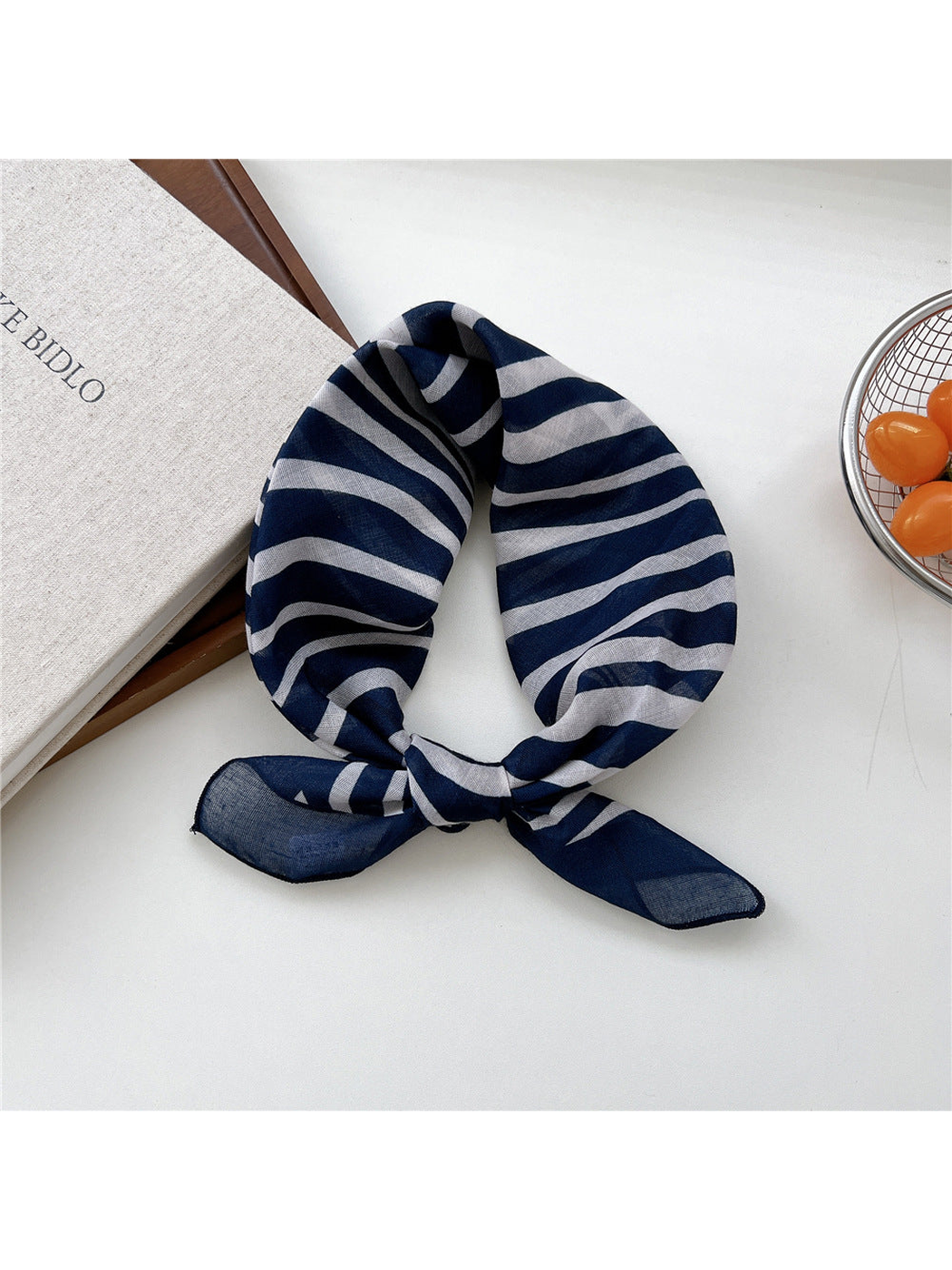 Navy Zebra scarf tied in a loop with irregular white stripes.