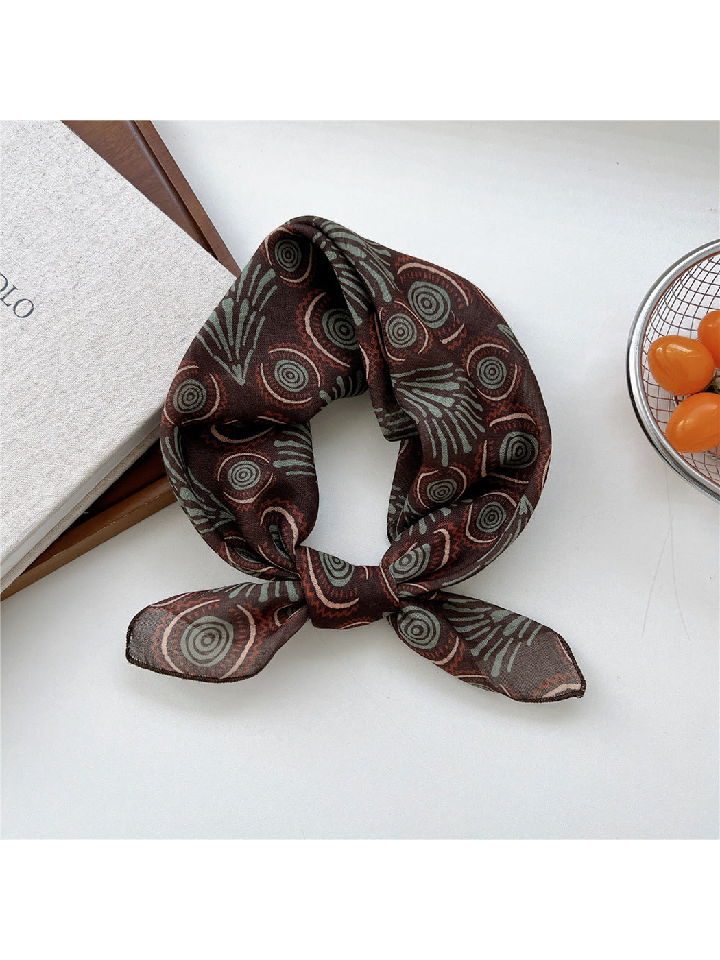 Brown Circles scarf tied in a loop with concentric circles and fan-shaped motifs.