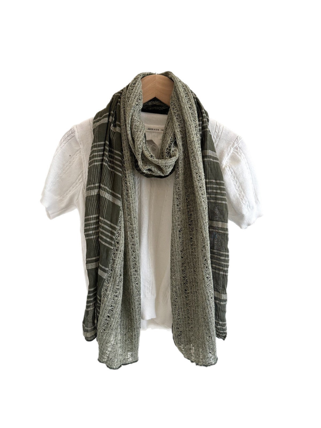 Army Green plaid scarf with openwork panels looped over a white top against a white background.