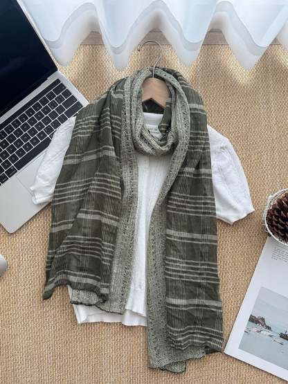 Army Green scarf arranged over a white top with broad plaid sections and an openwork center.