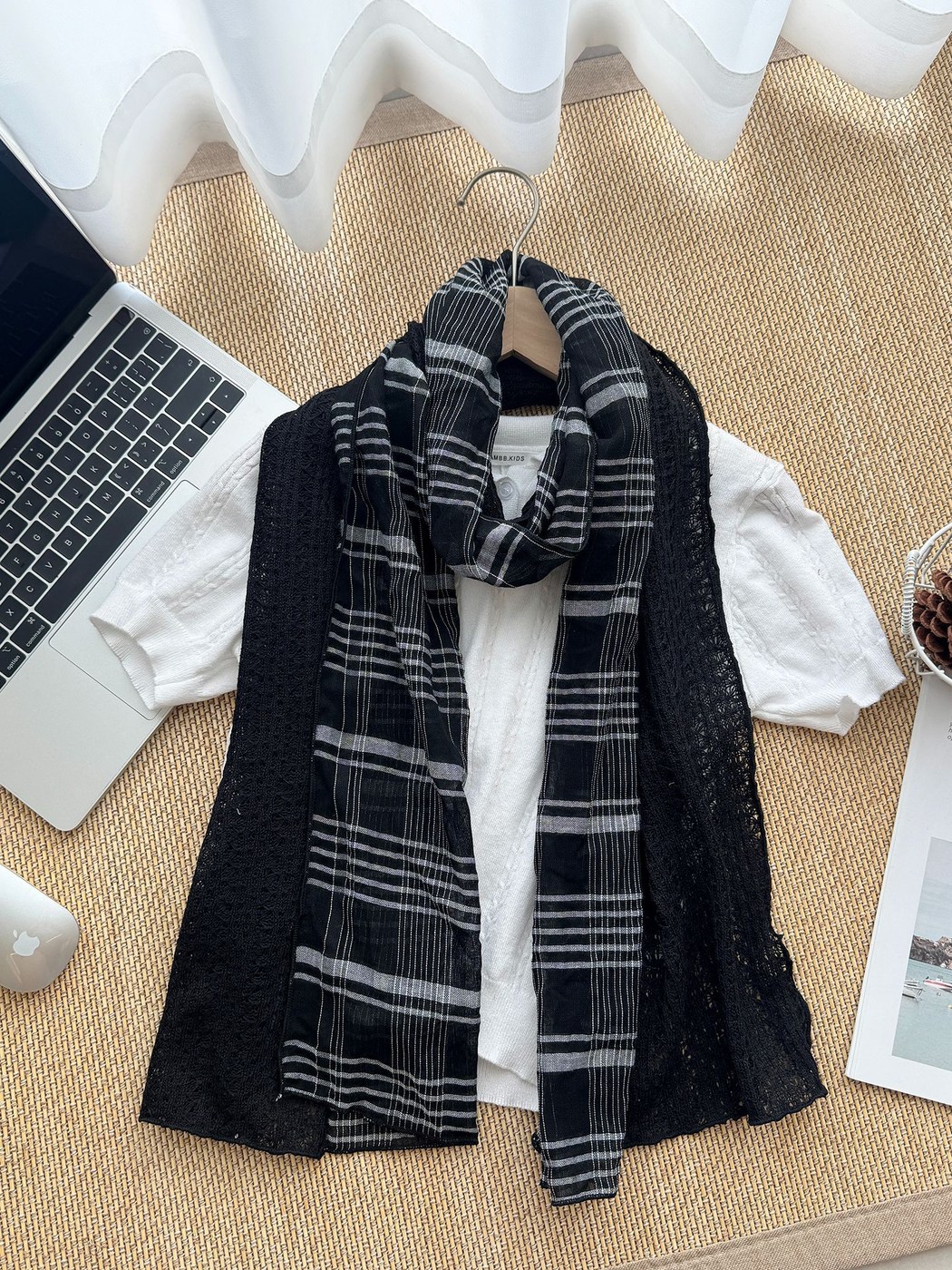 Black Gray scarf arranged over a white top with plaid sections at the center and openwork panels spread outward.