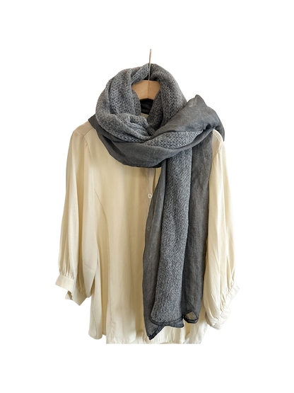 Dark Gray scarf with openwork and sheer panels looped over a cream shirt.
