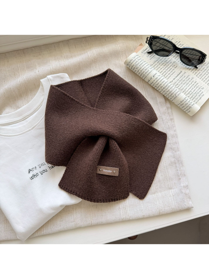 Dark Coffee knit pull-through scarf with a rectangular label near one end.