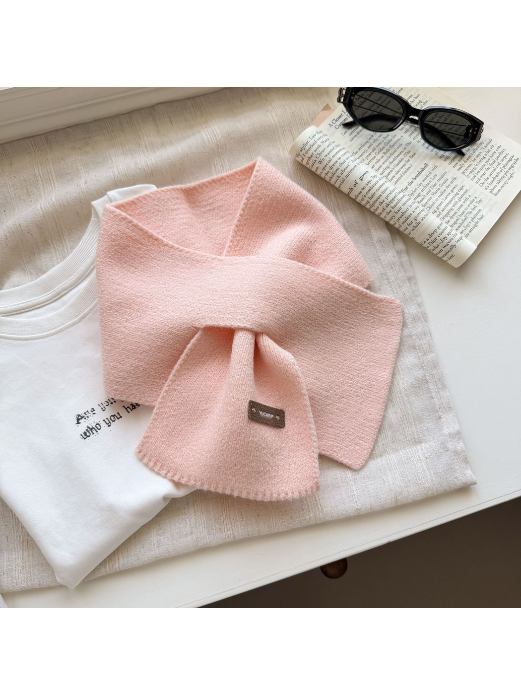 Light Pink knit pull-through scarf with a rectangular label near one end.