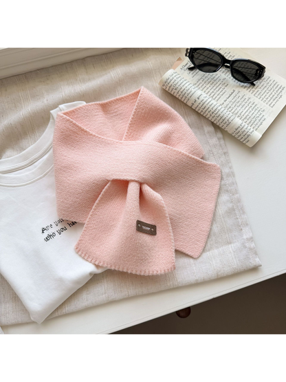 Light Pink knit pull-through scarf with a rectangular label near one end.