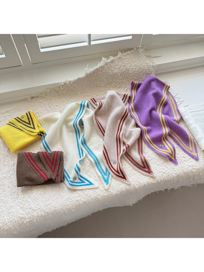Striped-border knit triangle scarves in Yellow, Brown, Ivory, Beige and Purple arranged on a textured surface.