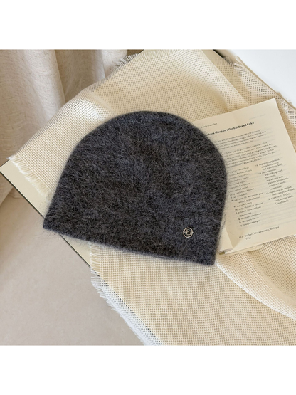 Dark Gray fuzzy knit beanie with a rounded crown and small silver-tone emblem.