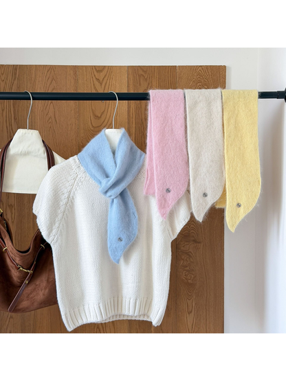 Sky Blue scarf looped over a white knit top beside hanging Light Pink, Ivory and Yellow scarves.