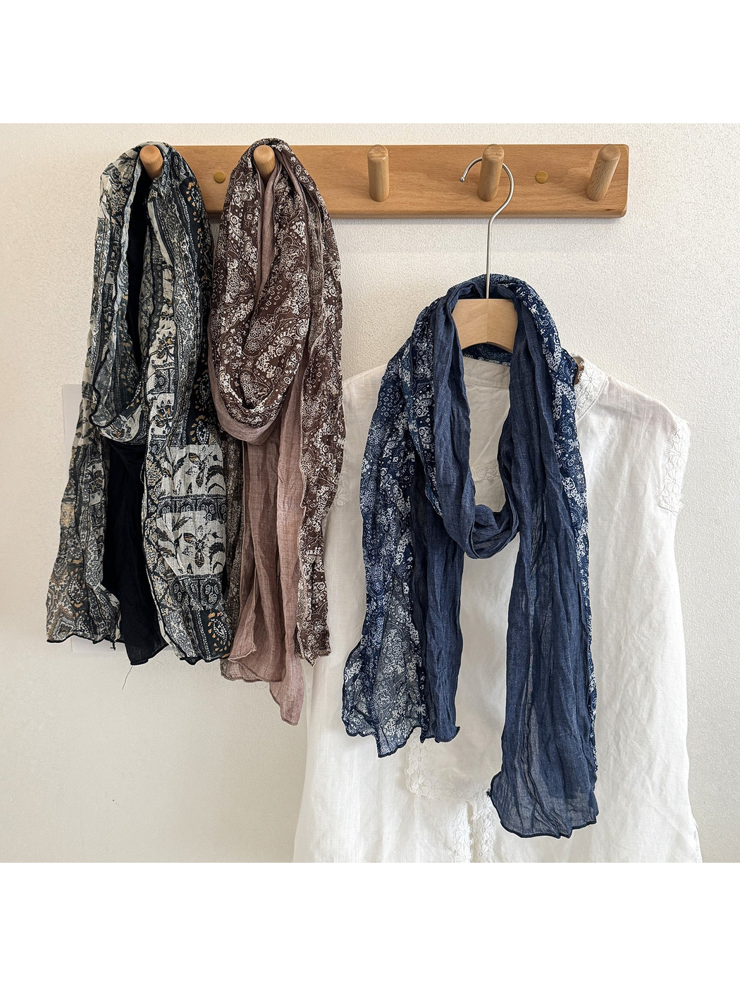 Black Gray, Coffee, and Navy scarves with contrasting printed and solid sections, draped together.