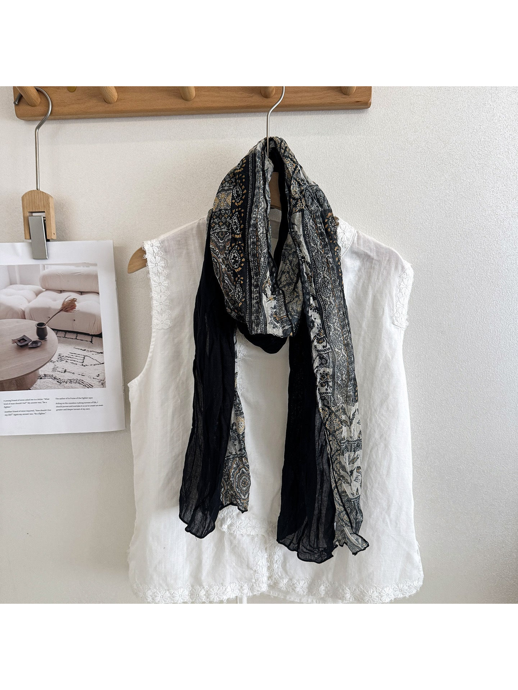 Black Gray scarf with ornamental printed and solid black sections, looped over a white top.