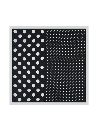 Black square scarf laid flat, with large and small white polka dots and a contrasting pale border.