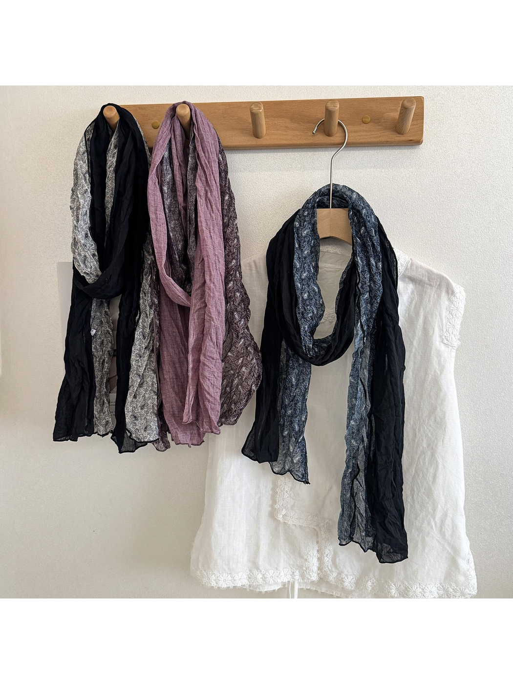 Navy, Black Gray, and Purple Burgundy paisley scarves hanging in long loops.