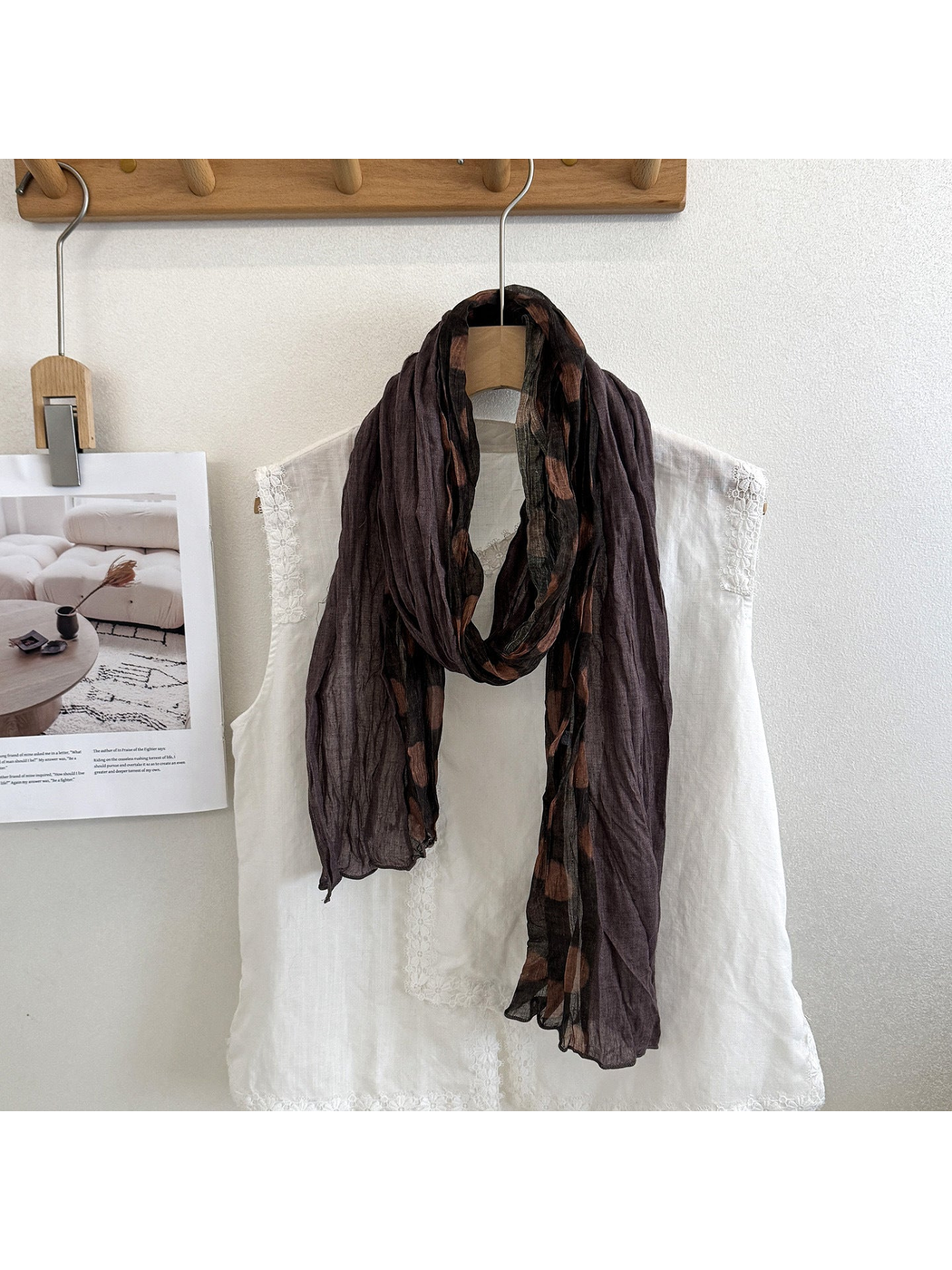 Coffee polka dot scarf looped over a white blouse, with long contrasting panels hanging down.