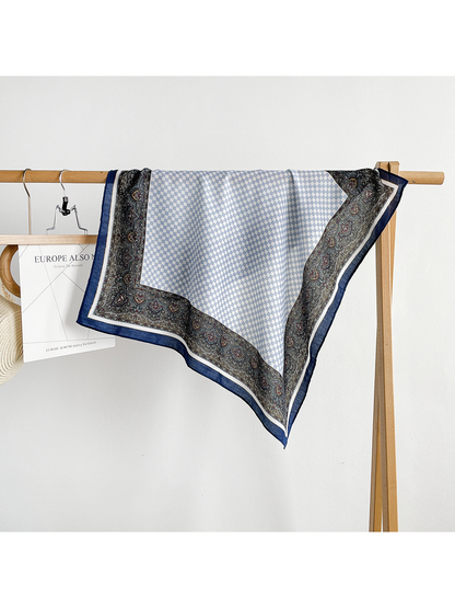 Blue Gray checkerboard and paisley scarf draped over a clothing rack.