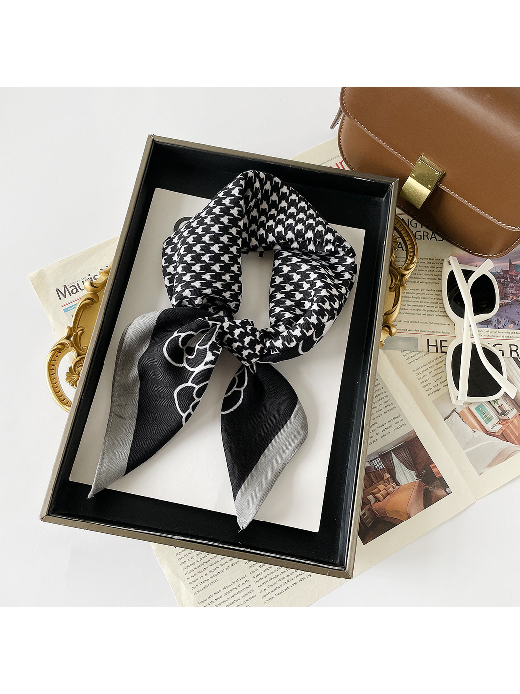 Black Gray scarf arranged in a knotted loop with white houndstooth and floral motifs.