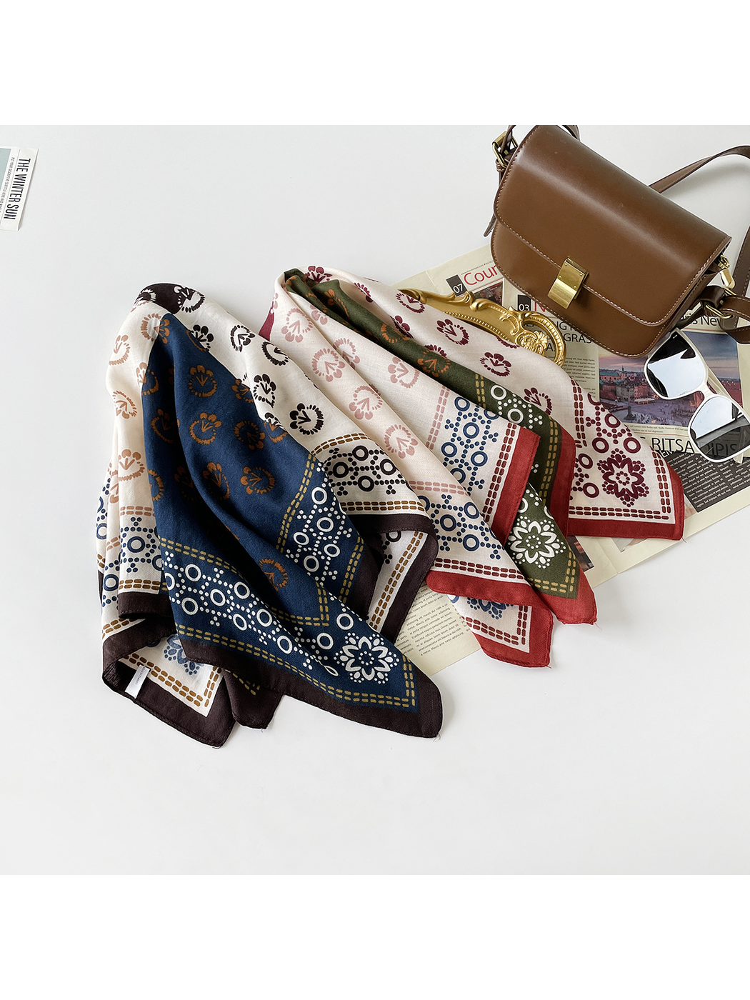 Burgundy and Navy Orange scarves draped side by side, showing contrasting color blocks and circular borders.
