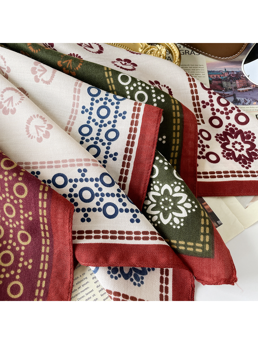 Close-up of the Burgundy scarf's herringbone texture, floral motifs, dotted rings, and red edge.