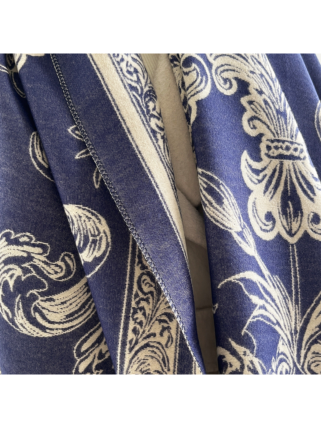 Close-up of the navy and ivory scarf pattern and finished edge