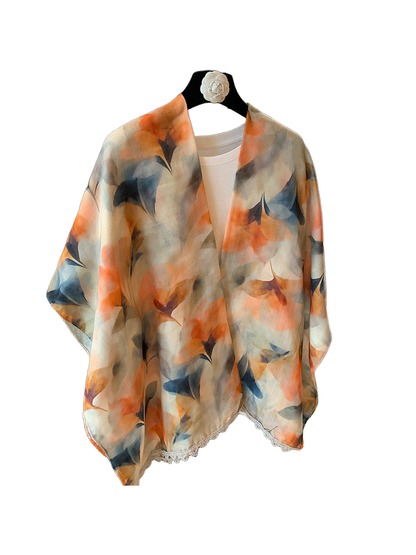 Multicolor abstract floral scarf draped over a white top, front view