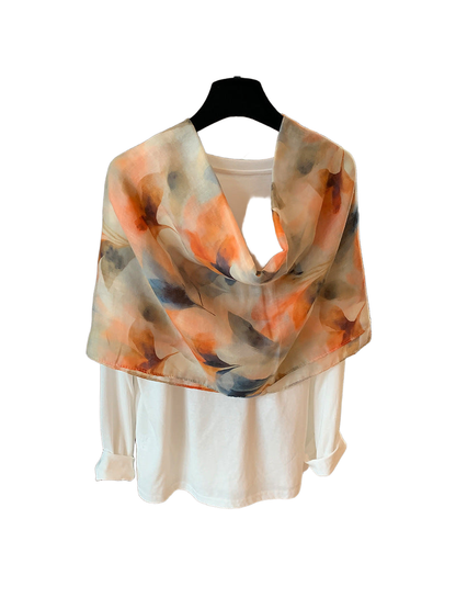 Multicolor abstract floral scarf draped over a white top, back view