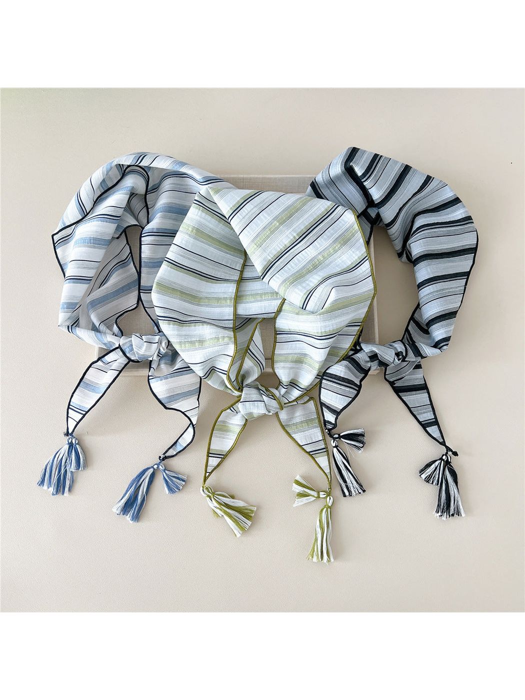 Black Gray, Blue Gray, and Green triangle scarves displayed together