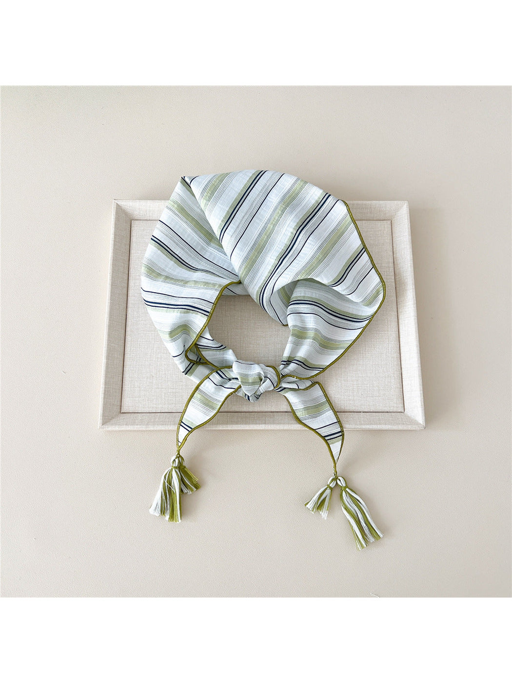 Green striped triangle scarf with tassel-ended ties