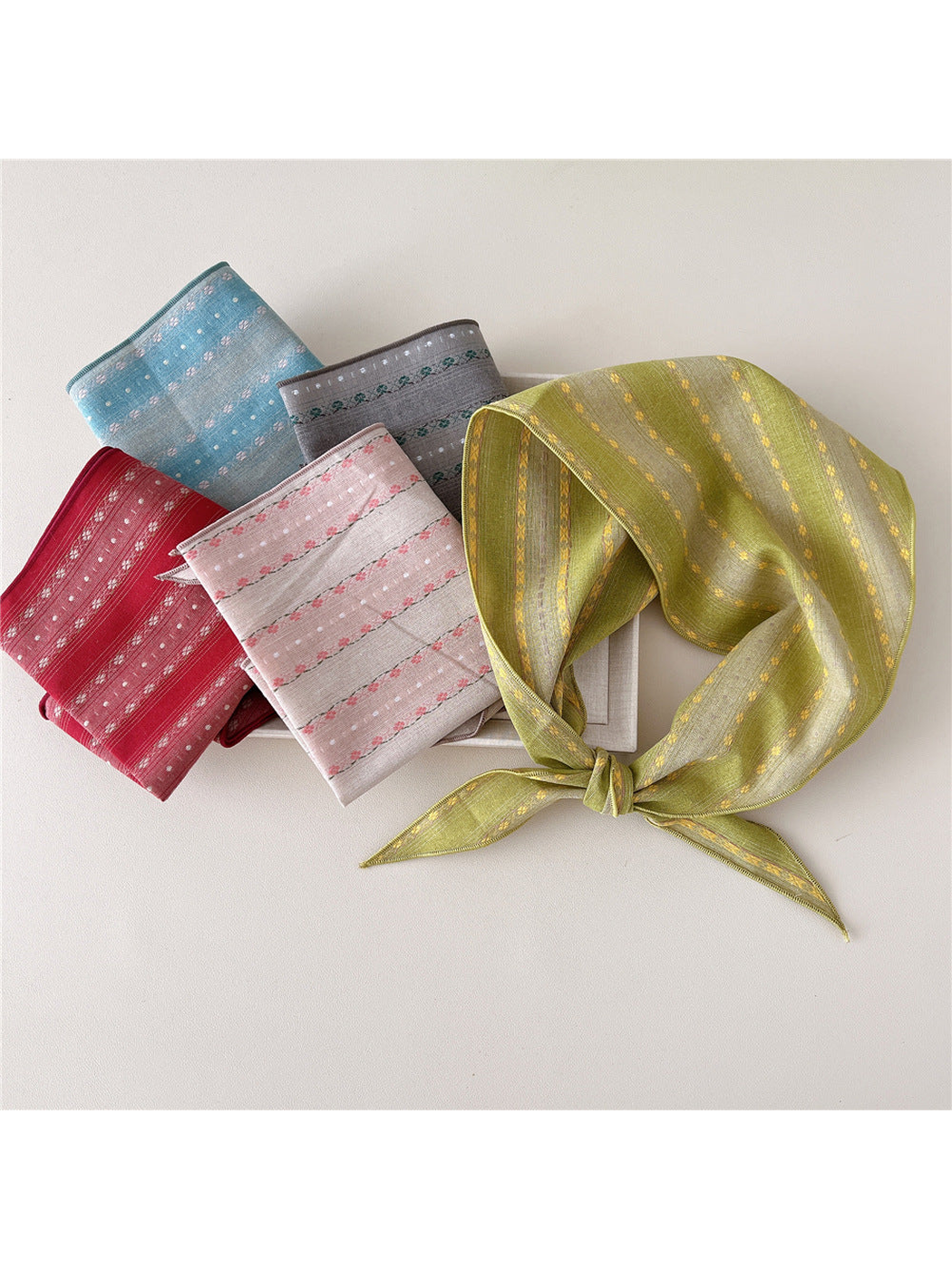 Five floral triangle scarf styles displayed together