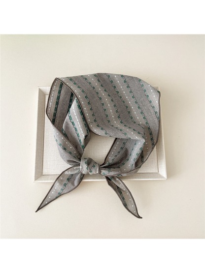 Gray Floral triangle scarf tied over a framed display
