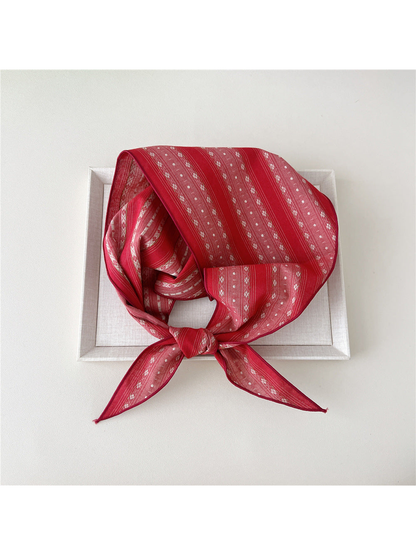 Red Floral triangle scarf tied in a loop