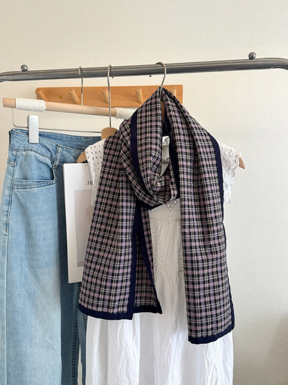 Purple Large plaid scarf with navy edging, draped on a hanger