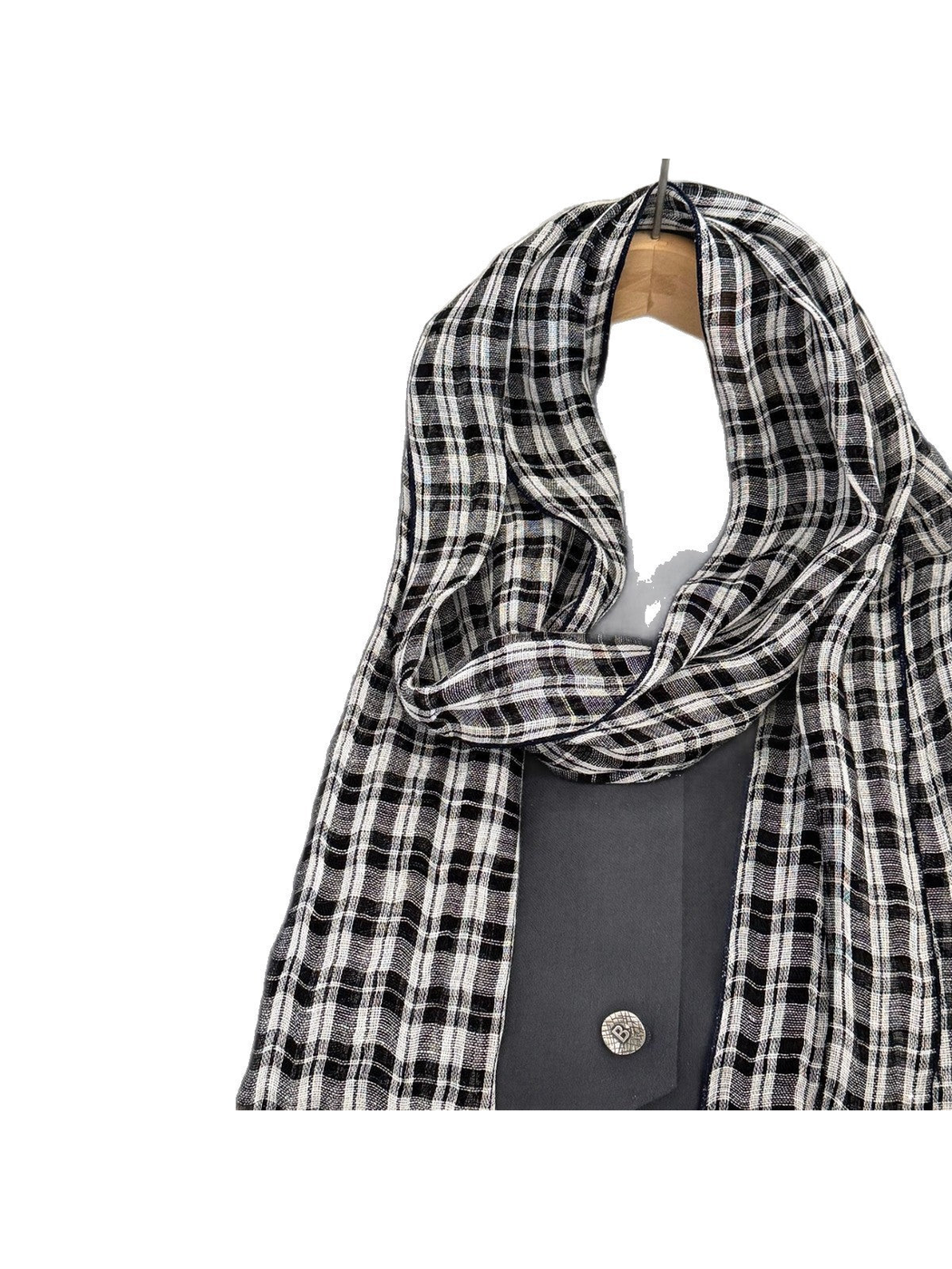 Close-up of the scarf's draped loop and plaid weave