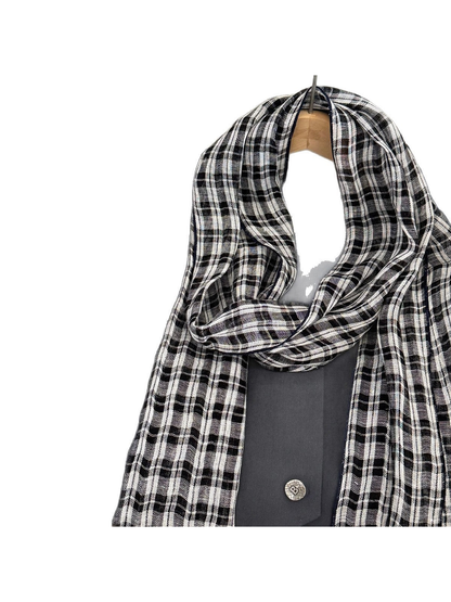 Close-up of the scarf's draped loop and plaid weave