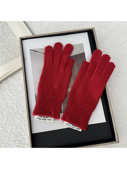 Red gloves displayed as a pair