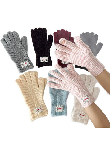 Pink gloves worn on hands with other colors arranged behind them