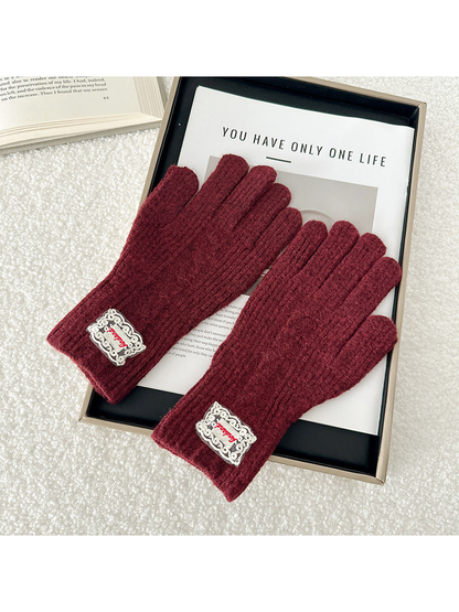 Burgundy cable-knit gloves with ribbed cuffs
