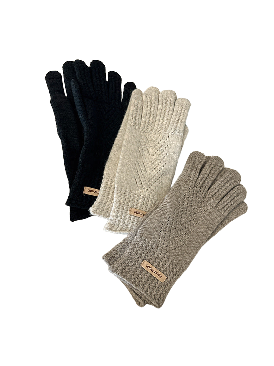 Black, ivory, and khaki gloves arranged beside a laptop