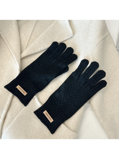 Black five-finger gloves with textured cuffs and chevron-like openwork lines