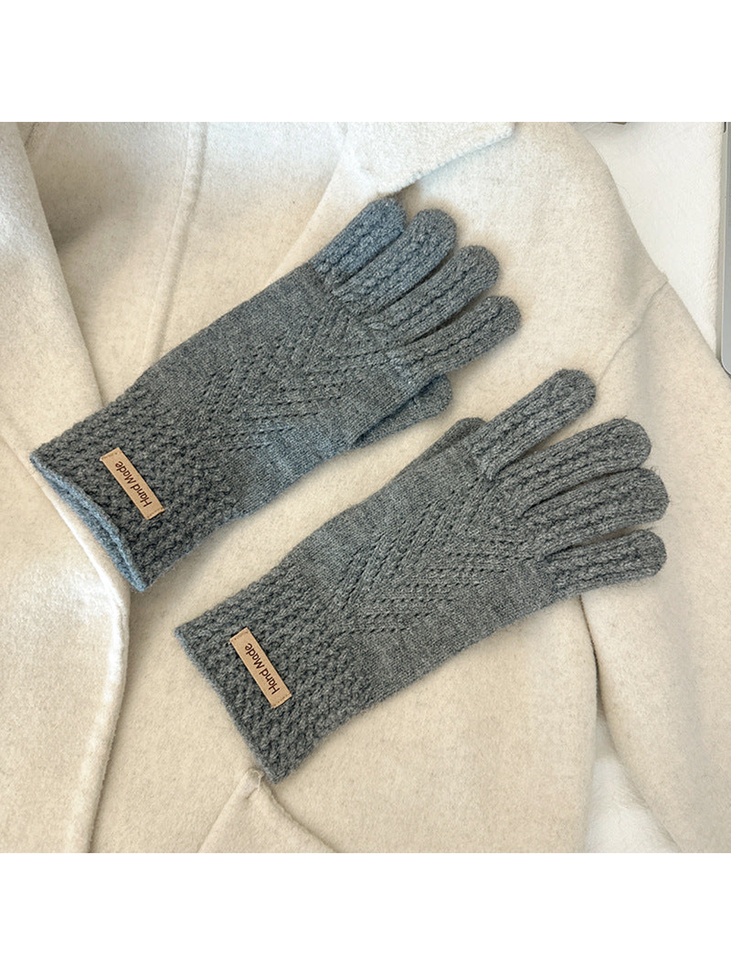 Gray five-finger gloves with textured cuffs and chevron-like openwork lines