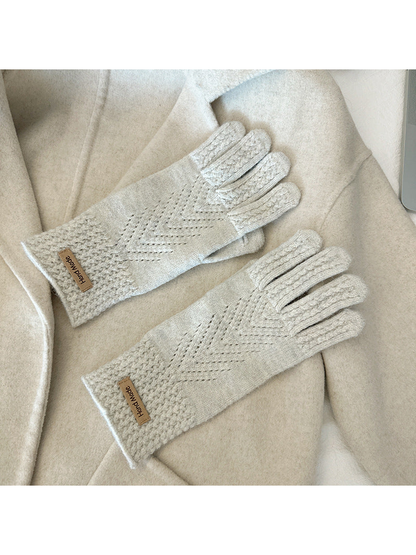 Ivory five-finger gloves with textured cuffs and chevron-like openwork lines