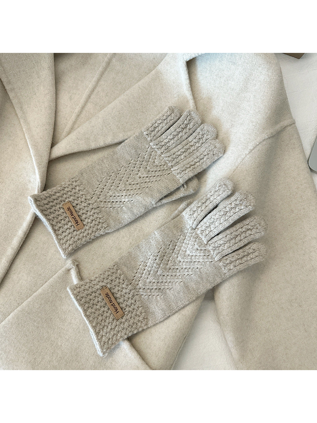 Greige five-finger gloves with textured cuffs and chevron-like openwork lines