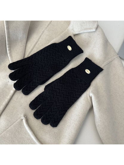 Black five-finger gloves with a repeating chevron knit pattern